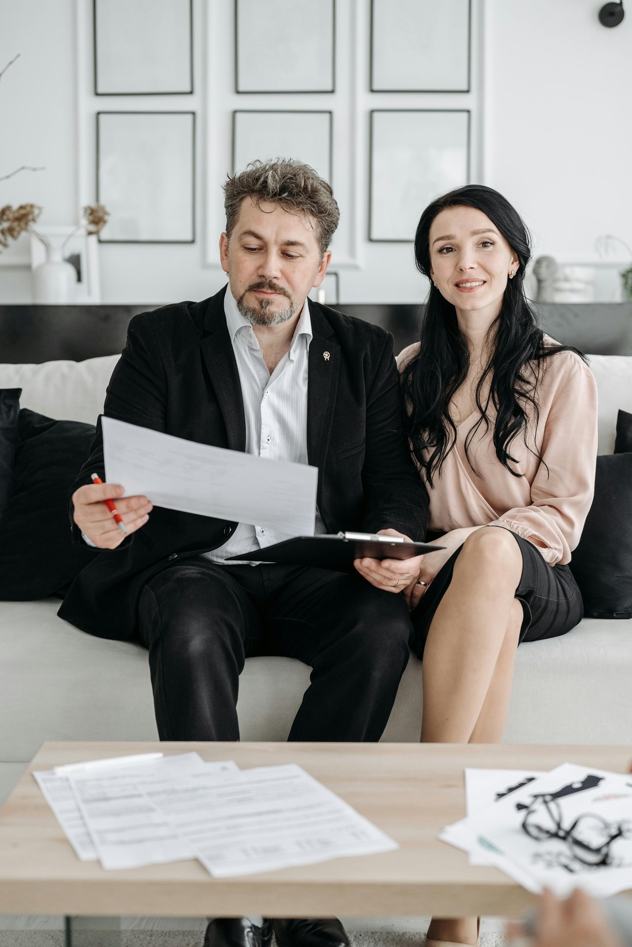 A couple reviewing and signing documents together at home