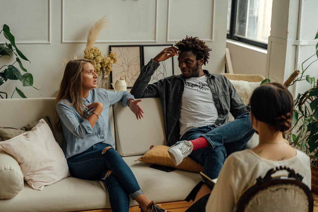 A young family relaxing together on the sofa at home