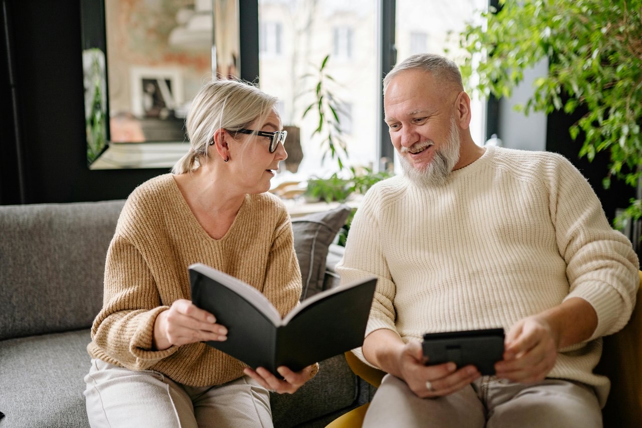 An older couple reading through documents together